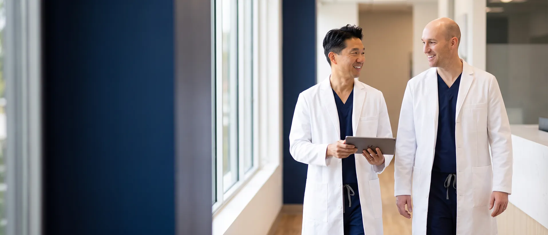 John Park, MD and Andrew Schroeder, DO walking through the VIS Omaha clinic